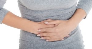 woman's stomach in pain from calcified fibroids