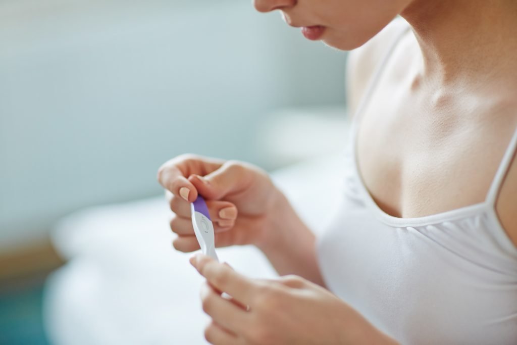 Stock image of a girl checking with pregnancy test kit