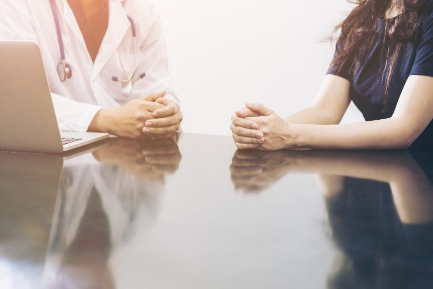 Doctor and patient consulting on a table