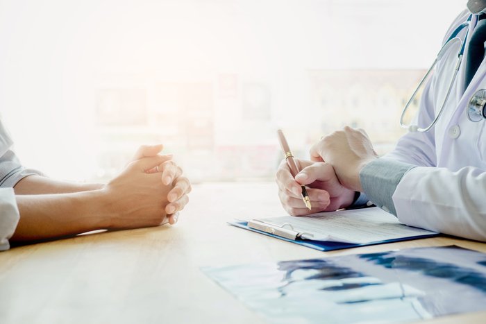 Doctors and patients sit and talk