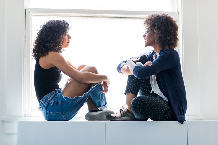 Two women sitting opposite each other